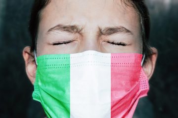 Upset teenager girl in medical mask with eyes closed.