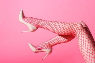 slender-female-legs-raised-sexy-pink-fishnets-matching-high-heels_126745-2524